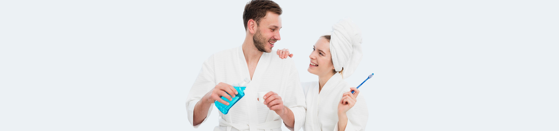 Smiling couple holding a mouth wash.