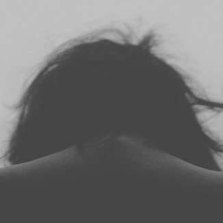 Central New England Dental social anxiety blog header dark image of woman hanging her head